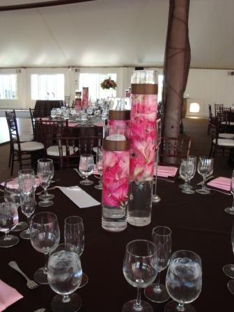 Her other centerpiece was 3 tall cylinder vases with brown ribbon around the