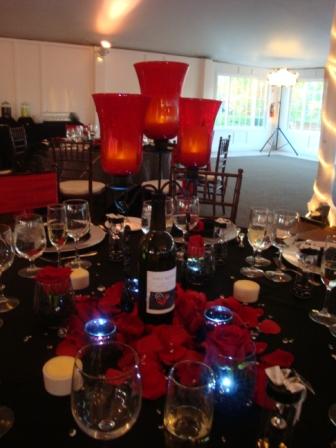 Centerpieces were wine bottles with black candlewine stoppers these had red