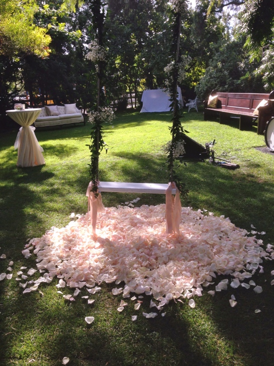 Mound of rose petals under the swing for Mackenzie & Joey's first picture of Husband & Wife.